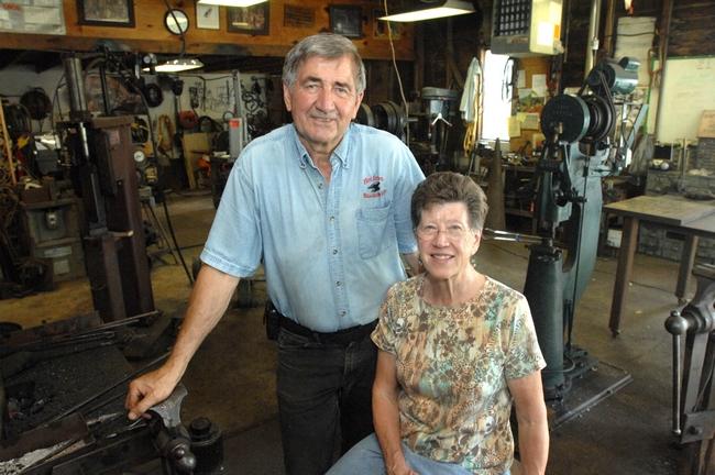 Bud and Janelle Harvey pose for a portrait in the well-equipped blacksmith shop behind their Chillicothe home. Bud took his first blacksmith class several years before retiring from Caterpillar where he worked as at metalurgical engineer.